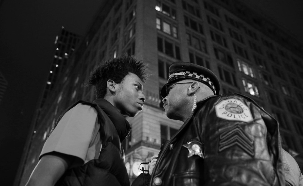 Contemporary Issues 3rd place. Lamon Reccord stares down a police sergeant during a protest following the fatal shooting of Laquan McDonald by police in Chicago, Illinois, USA.