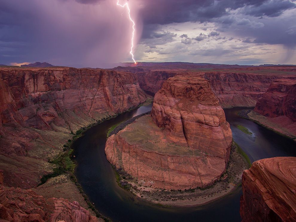 2 Striking View. Photograph by J. Cho. 
Lightning strikes beyond the rim of Arizona’s Horseshoe Canyon in this picture submitted by J. Cho. “It’s just amazing and beautiful,” Cho writes, noting that the movement of the storm in the background makes the scene come alive. Located within Glen Canyon National Recreation Area, the site is named for the distinctive bend of the Colorado River, which flows a thousand feet below the top of the cliffs.