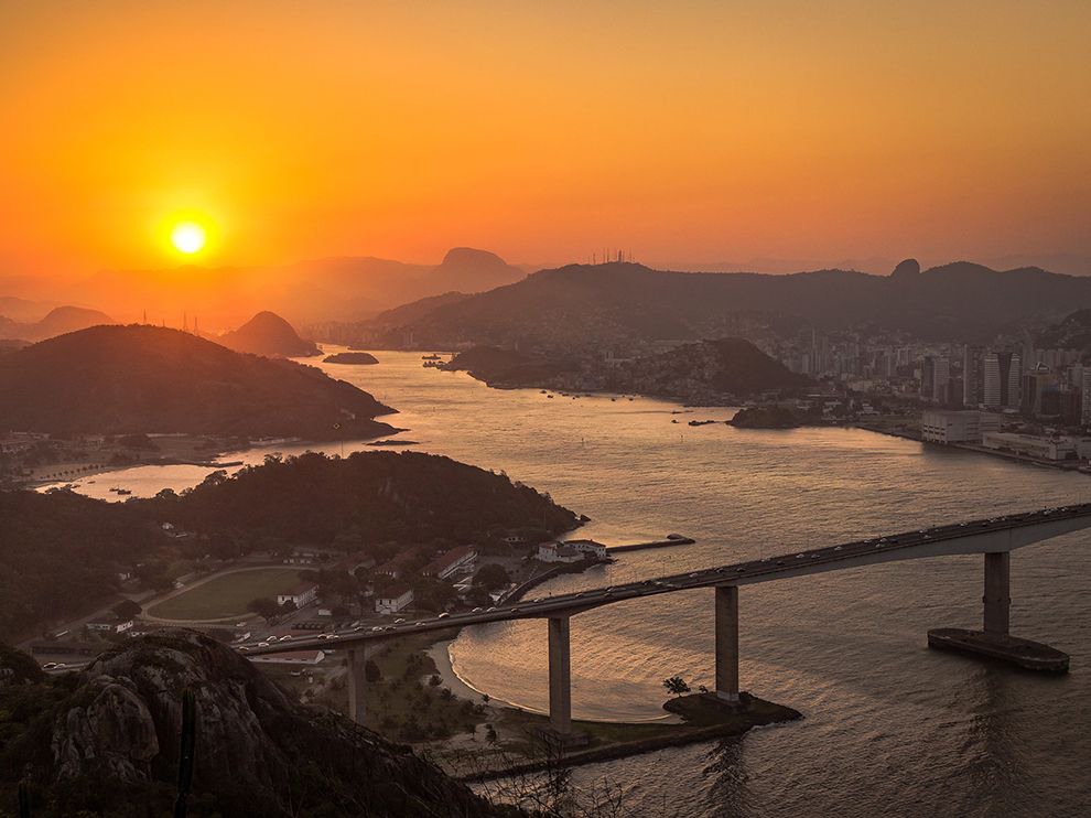7 Coastal Setting. Photograph by Victor Lima. 
The setting sun sinks behind the low mountains framing Vila Velha, a coastal city in the Brazilian state of Espírito Santo. Your Shot member Victor Lima captured this dusky view of the bay and its surrounds from the Morro do Moreno, or Moreno Hill.
