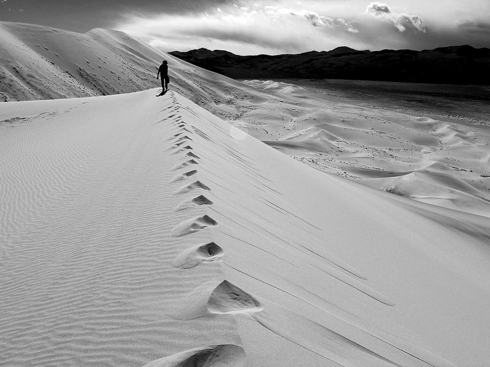8 Death Valley Dunes. Photograph by Kim Mitchell. 
The Eureka Dunes in Death Valley National Park offer an eerie soundtrack to visitors who decide to make their way up the sandy slopes—a mysterious phenomenon known as singing sand results in heavy bass notes and drones that sound like they come from airplanes. The booming sounds only add to the desolate beauty of the dunes, the tallest in California.