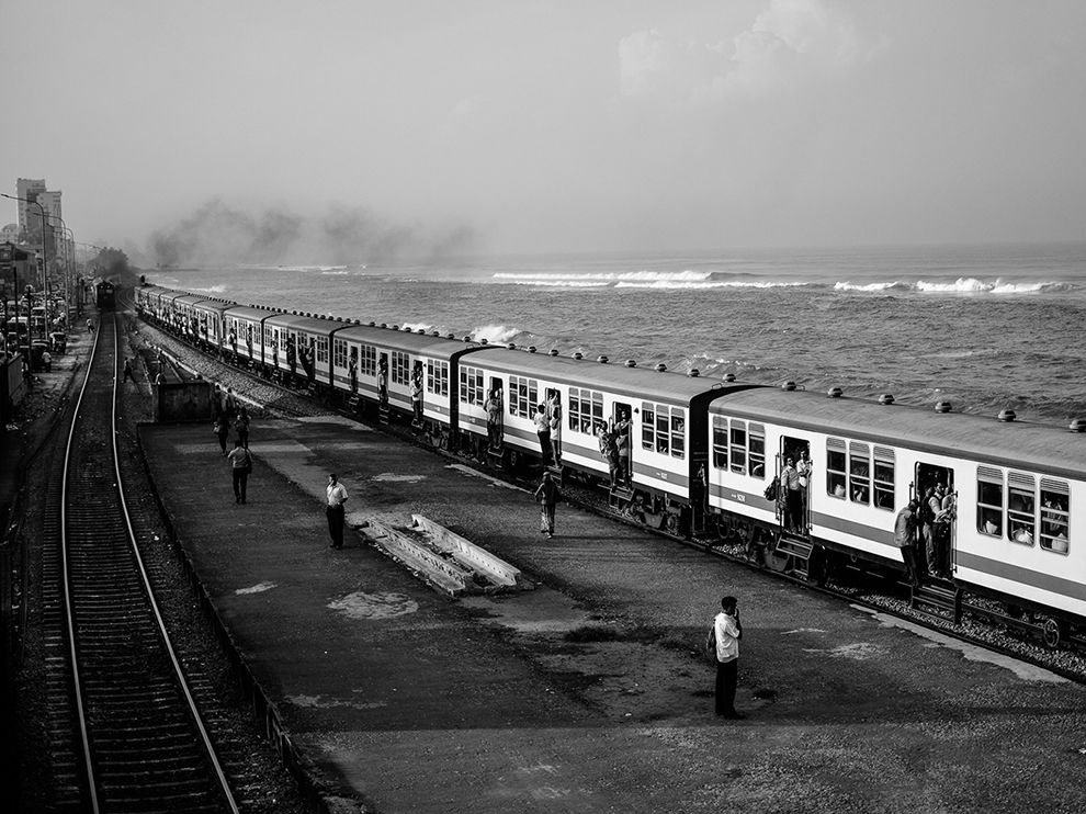 21 Coastal Commute. Photograph by Marcel Koláček.
Shot in black and white, Marcel Koláček’s recent photo of a scene at the Colombo Fort Railway Station in Colombo, Sri Lanka, looks like it could have been taken decades ago. Indeed, the station has been around for some time—in operation since 1908, it is a Sri Lanka Railways hub.