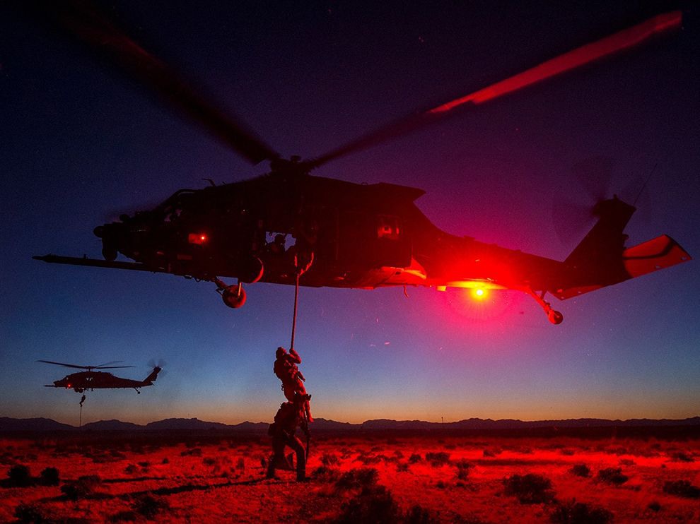 29 Maneuvers in the Dark. Photograph by Jodi Martinez. 
U.S. military special forces members conduct fast rope and hoisting training during exercises at Holloman Air Force Base in New Mexico.