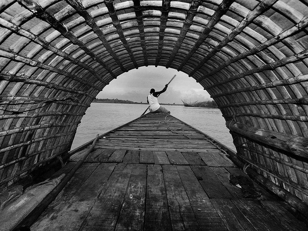 9 The Boatman. Photograph by Sirsendu Gayen. “It was just before the autumn in Bengal, when I was searching for kash flower[s] here and there,” writes Sirsendu Gayen, a member of our Your Shot community.     “On receiving positive news from my friend ... I managed to travel by a country boat through the Ganges beside Mayapur in [the] Nadia district of West Bengal. To my utter surprise it was a rainy day. The sky was fully covered with dark cloud[s]. Naturally, I was not at all happy with it. So I thought to capture something different, and ultimately I shot this picture, where I have tried to demonstrate the breaking of [a] scene down into graphic shapes and lines.”