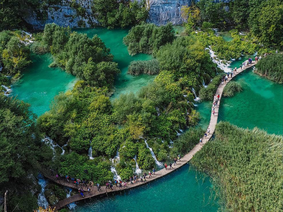 10 Above the Boardwalk. Photograph by Robert Klaric. People stroll on a wooden walkway through Plitvice Lakes National Park in Croatia. Your Shot member Robert Klaric writes that, with its crystal-clear waters, cascades, and waterfalls throughout the area, the park “will take your breath away.” He noticed the people walking below and stopped to make this image. “The light and the view were perfect,” Klaric says.