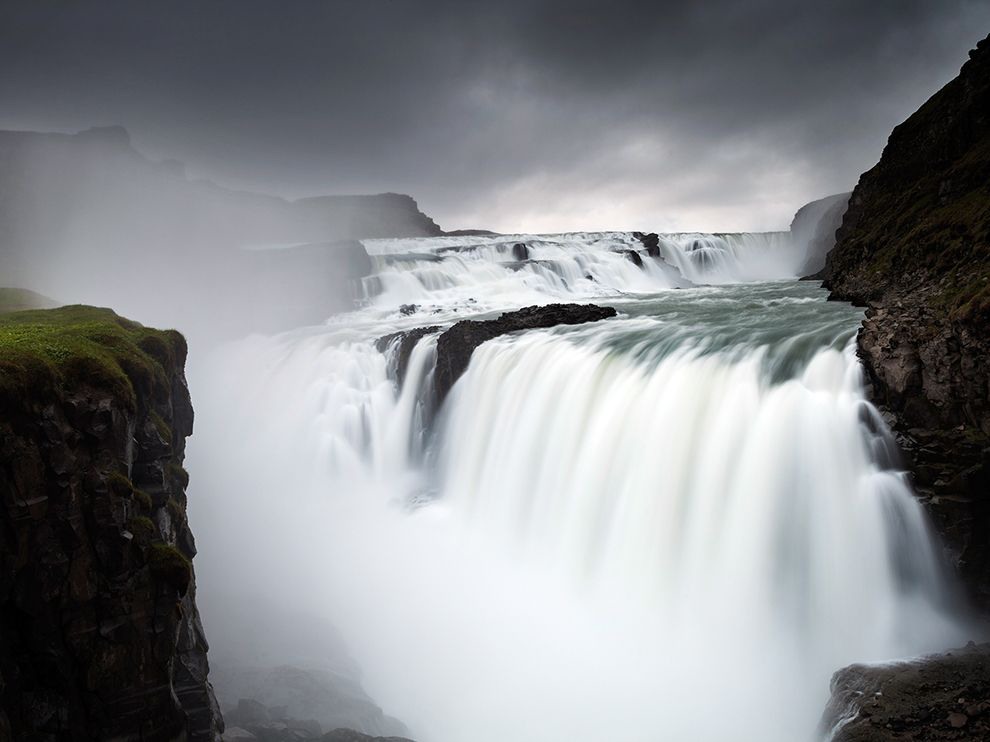20 Cold Rush. Photograph by Andrea Centon. "A light mist rises from Iceland’s Gullfoss (Golden Falls) as it plunges in steps to the canyon below. The mighty flow is located on the Hvítá River, which in turn is fed by Iceland’s second biggest glacier, the Lángjökull."