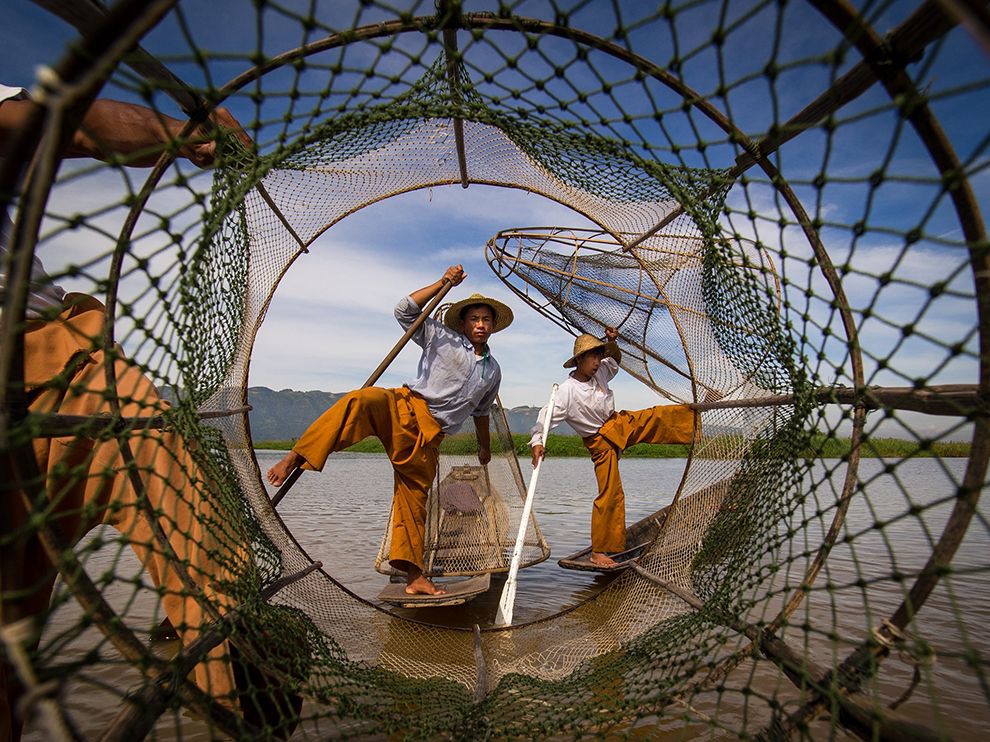 27 Balancing Act. Photograph by Marco Marcone. Your Shot member Marco Marcone snapped this artfully framed shot of fishermen balancing on small fishing vessels on Inle Lake in Myanmar. “I was in a boat a little bit larger than that of the fishermen in the photo," he writes. "Honestly, they were just there for tourists … Anyway, I tried to do something new. I [hadn’t] seen anyone before [put] the camera and himself inside the fishing net!"