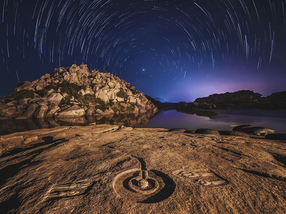 29 Celestial Spin. Photograph by Alexander Grabchilev. Your Shot community member Alexander Grabchilev submitted this image of star trails over Karnataka, India. He made this photo while visiting Hampi, a UNESCO World Heritage site and the location of the extensive ruins of the Hindu city of Vijayanagar, built in the 14th through 16th centuries.
Grabchilev explains his process for photographing the star trails: “I [did] about a hundred shots with a 40-second exposure, one by one, and [the shots were] stitched in post-processing.”