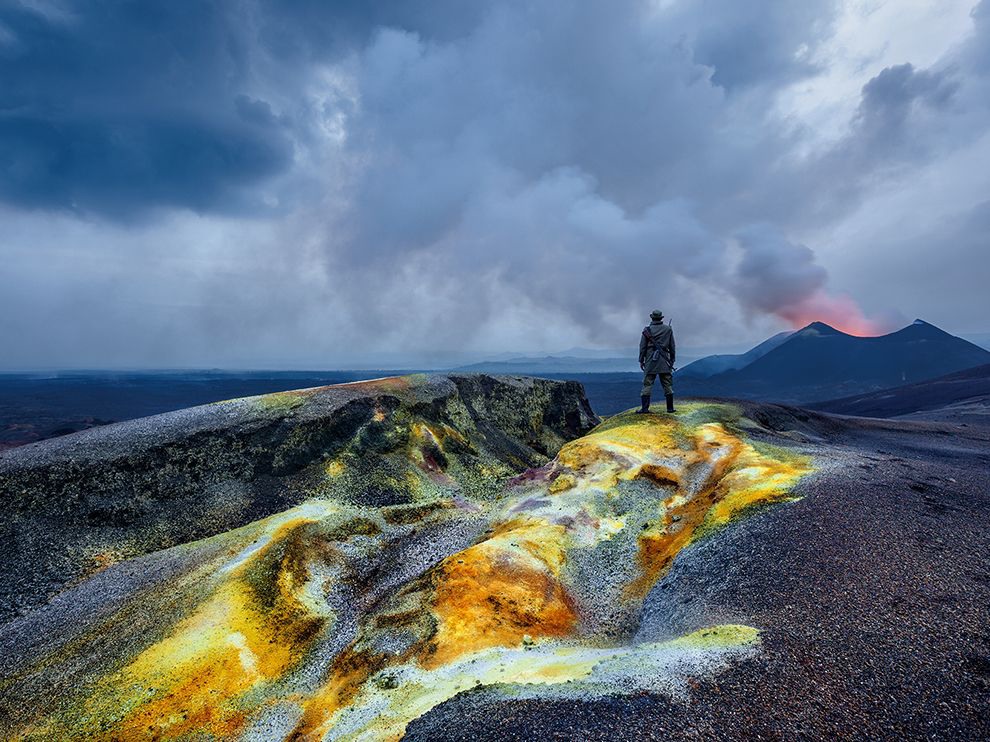 2 Hot Spot. Photograph by Brent Stirton. In the Democratic Republic of the Congo's Virunga National Park, a ranger surveys a new lava field created by Nyamulagira, the most active volcano in Africa. The 10,033-foot peak erupts roughly every two years. In the foreground is a sulfur deposit from a recent eruption.