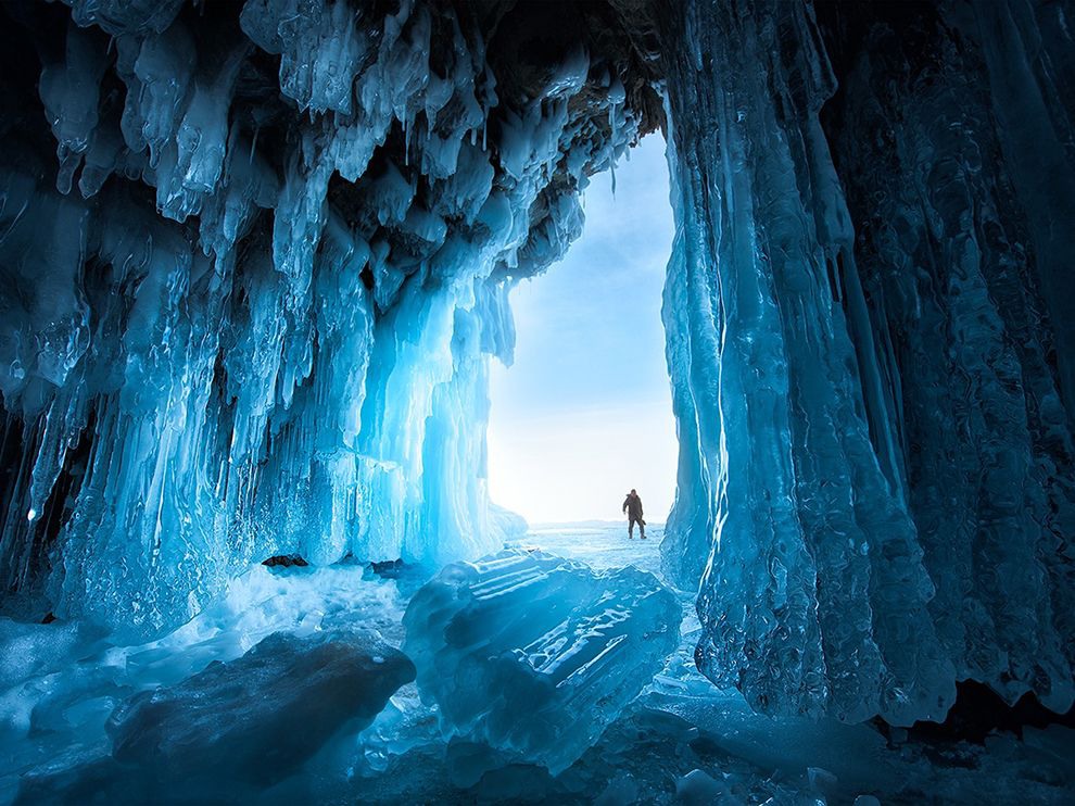 18 Crystal Cave. Photograph by Xiao Zhu. An ice cave beckons on Lake Baikal, the world’s oldest and deepest freshwater lake, located in Siberia. Photographers eager to capture an image like this one should be ready to brave the bone-chilling Siberian winter, which renders Lake Baikal sealed by a thick sheet of ice between November and March.