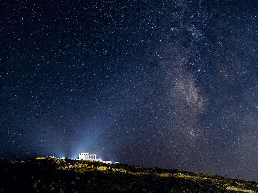 22 Sea Meets Sky. Photograph by Vincent J. Musi. Floodlights illuminate the temple of Poseidon, god of the sea, at Cape Sounion, Greece. The cults of ancient Greece helped define our ideas of the afterlife today.