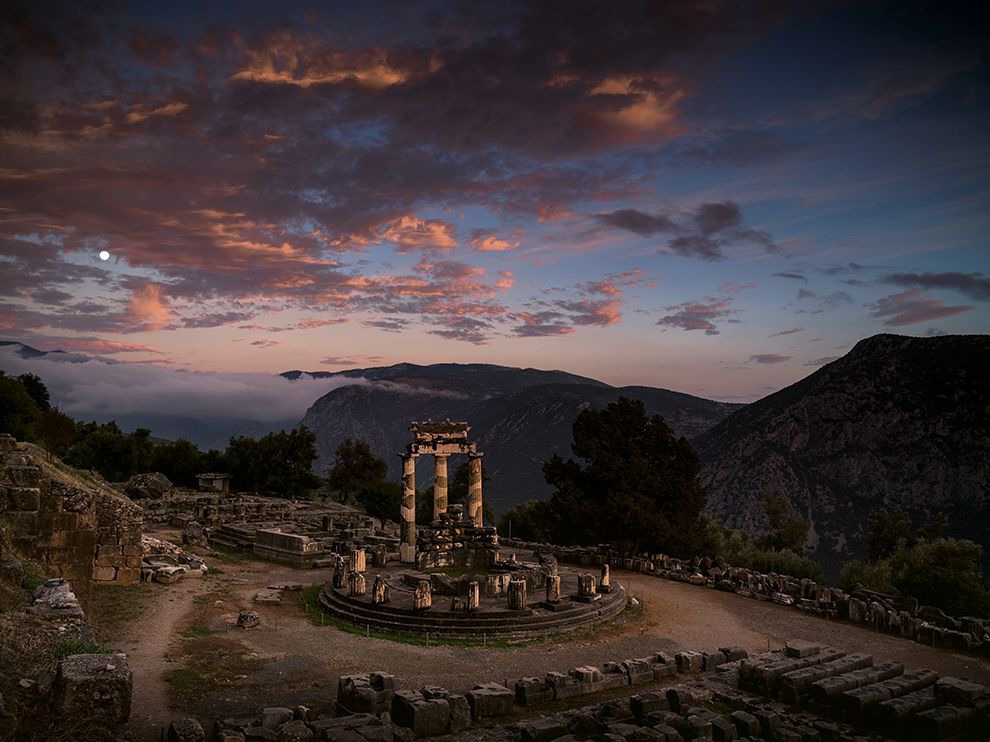 27 Ruins of Worship. Photograph by Vincent J. Musi. In Greece, twilight bathes the ruins of the sanctuary of Athena Pronaia at Delphi and its tholos, a circular building. Pilgrims may have offered sacrifices here before consulting the oracle of Delphi at the nearby temple of Apollo.