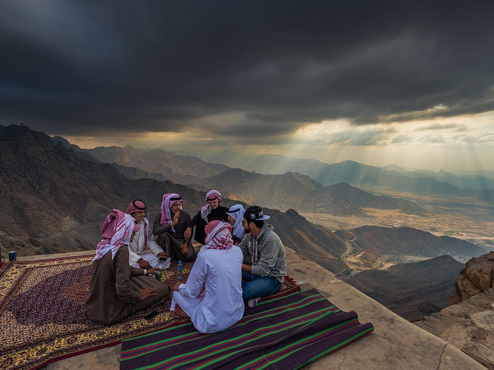 31 Friends in High Places. Photograph by Abdullrahman Almalki. While men chat on a perch in the Sarawat Mountains, sun rays create a dramatic sky over the valley below. Your Shot photographer Abdullrahman Almalki says the view “[overlooks] the city of Mecca,” Islam’s holy city.