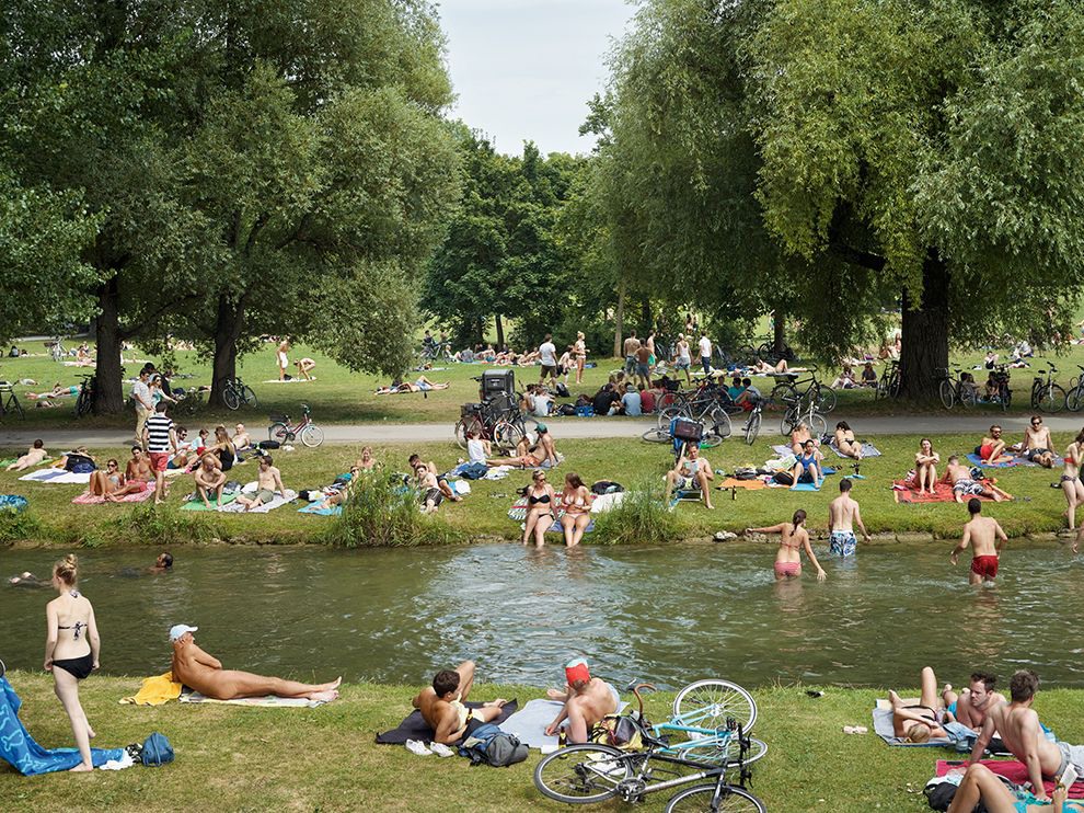 19 "Au Naturel". Photograph by Simon Roberts. In Munich, Germany, summer attracts sunbathers, clothed and otherwise, to the grassy banks of the Schwabinger Bach. The English Garden park opened in 1792 and is one of Europe’s largest. Its meadows have been popular with nudists since the 1970s.