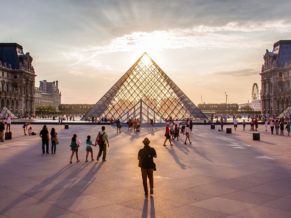 29 "Aglow in the City of Light". Photograph by Noemie Trusty. Your Shot community member Noemie Trusty submitted this stunning photo taken in the City of Light: the sun gleaming through the apex of the glass Louvre Pyramid, designed by architect I. M. Pei.